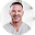 Supzential founder, smiling warmly in a professional light-colored shirt against a clean background.