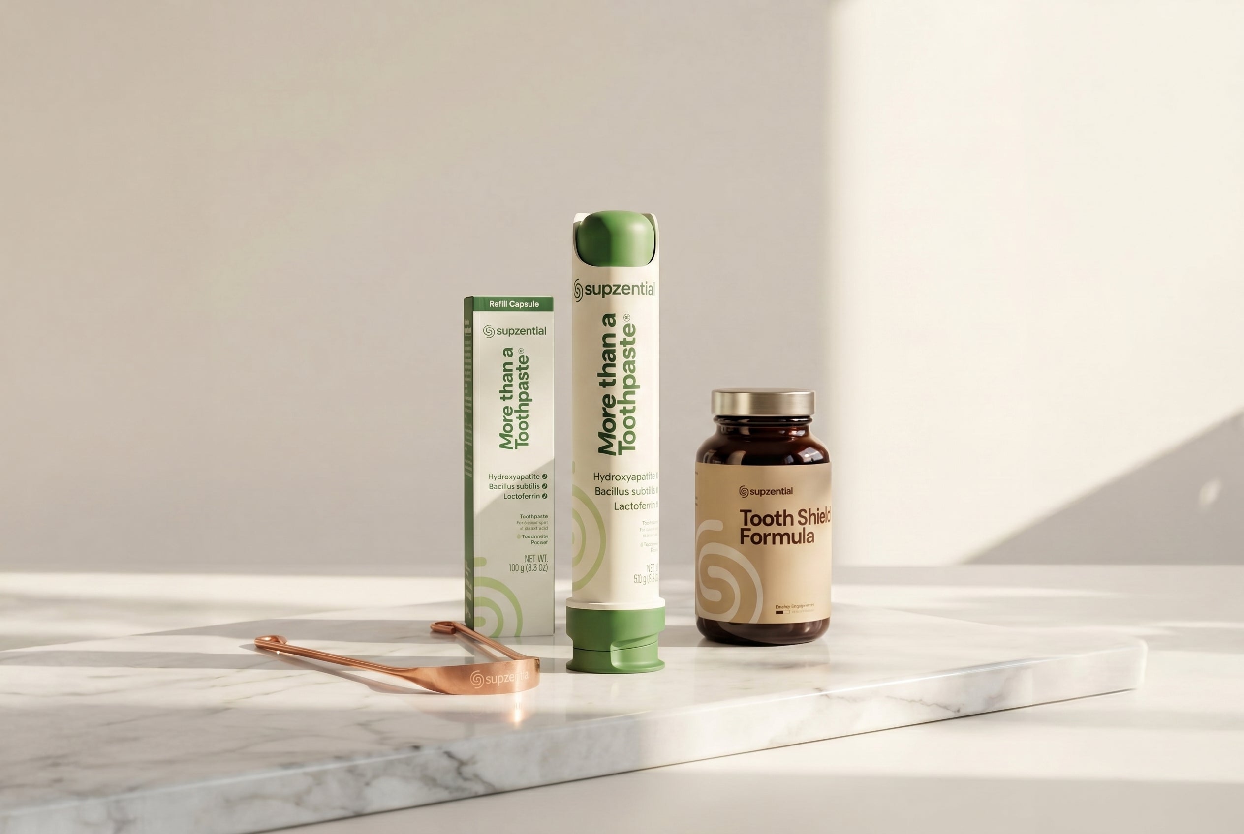 Two toothpaste tubes and a supplement bottle on a marble surface with a light gray background